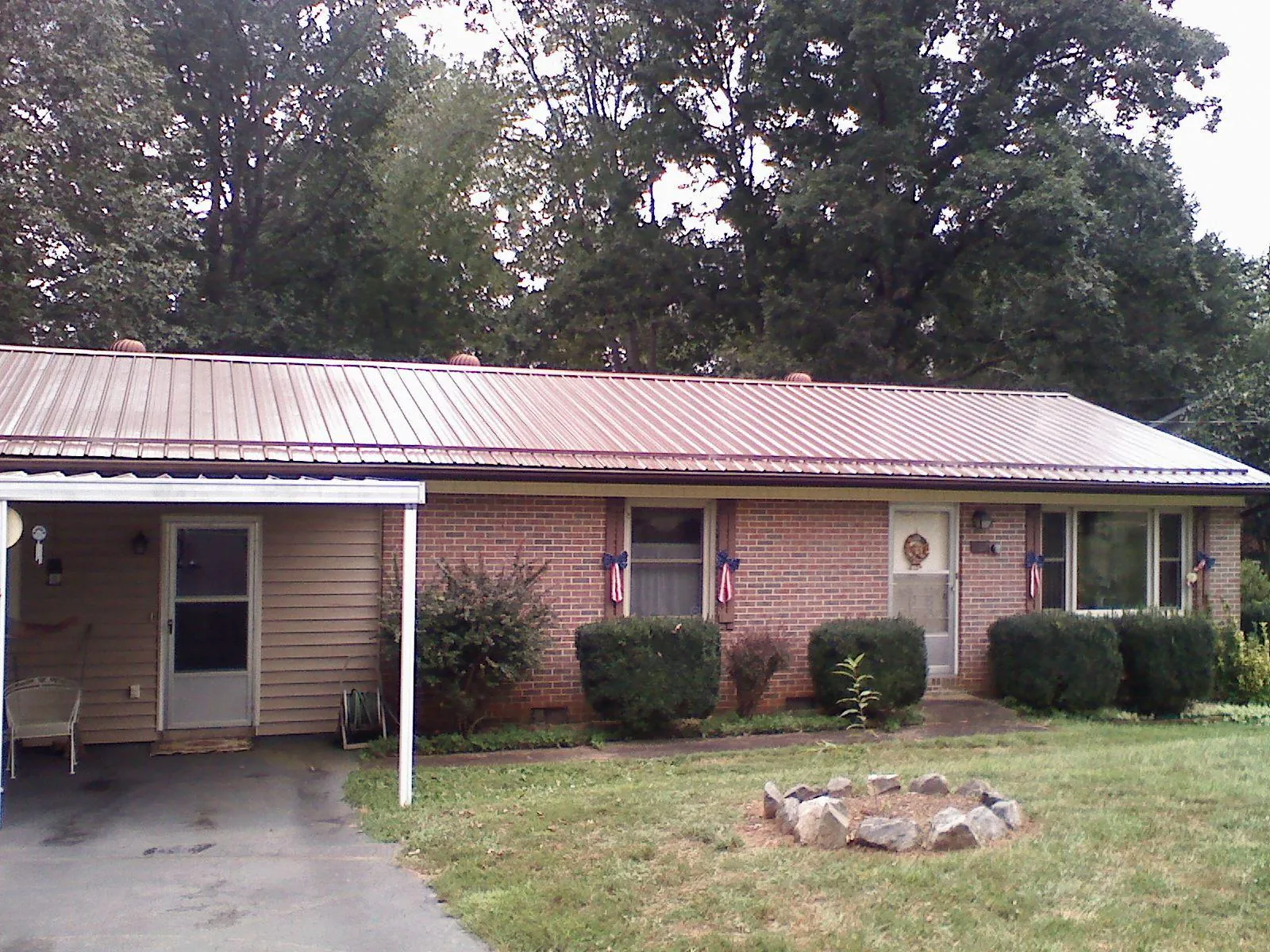 Bronze metal roof and carport on a brick ranch home — Roof Repair work by our crew in Windsor Locks