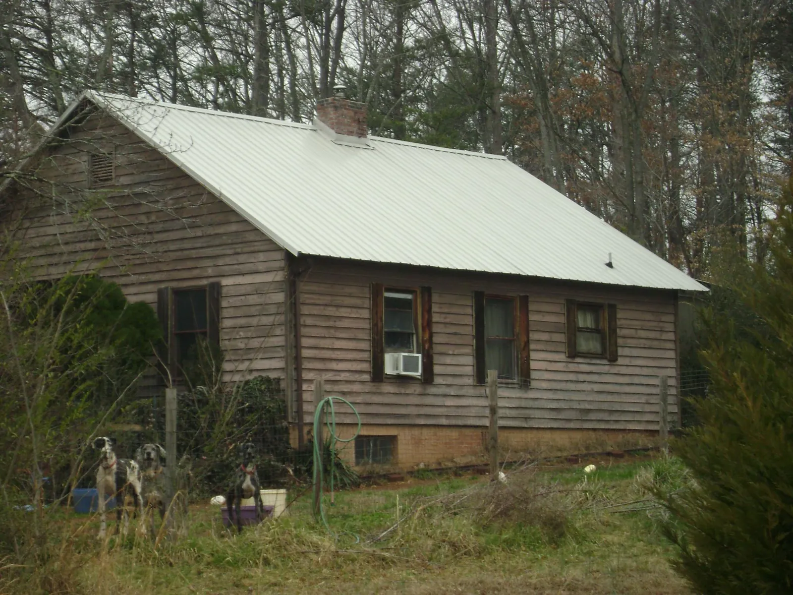 White metal roof on an old wood sided farmhouse, from a Metal Roof Installation job in Windsor Locks